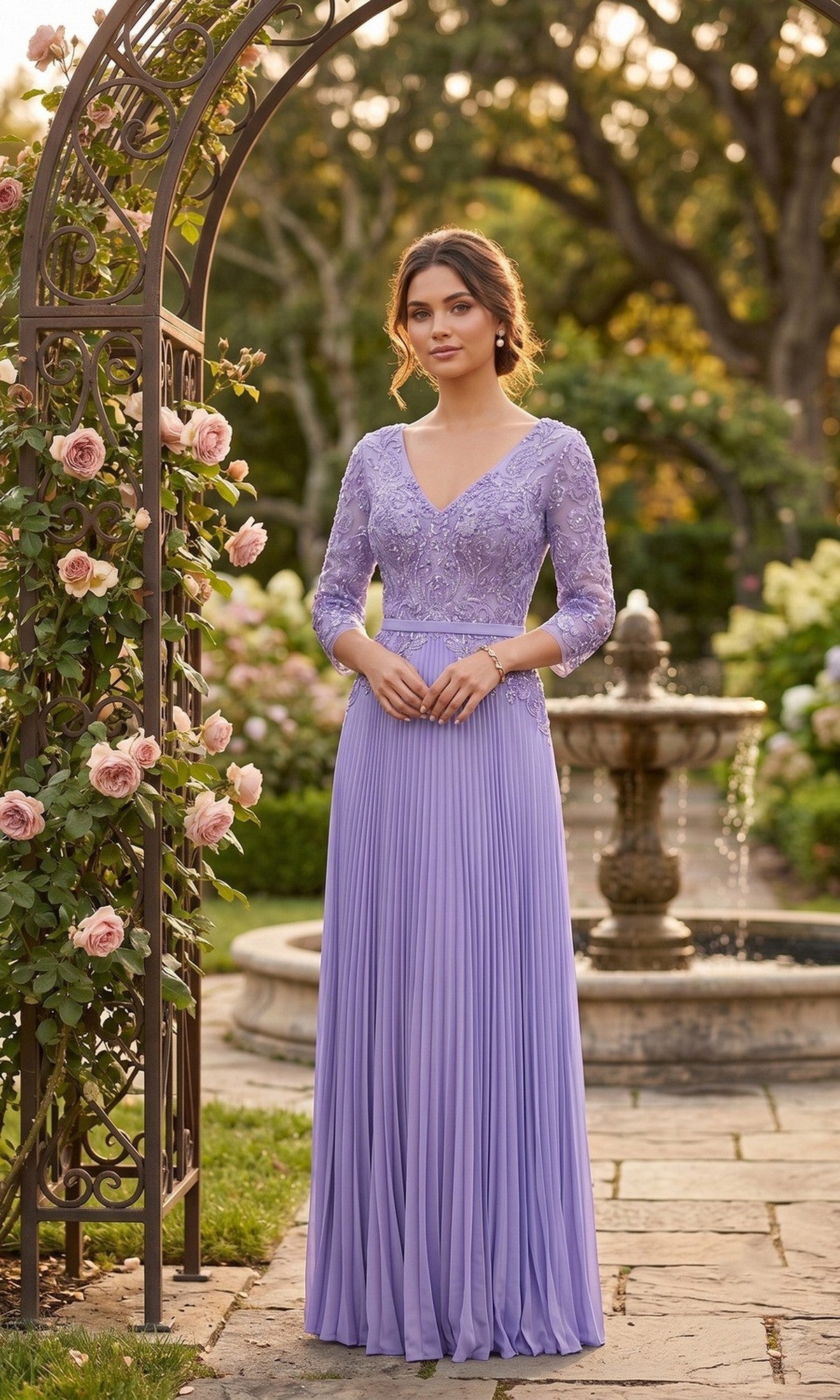 A woman in a lavender Long Formal Dress: Chicas YG5038 stands on a garden path near a metal arch with roses, with a fountain and greenery in the background.